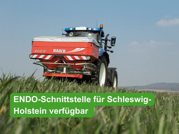 Traktor mit Rauch Düngerstreuer fährt über ein Feld